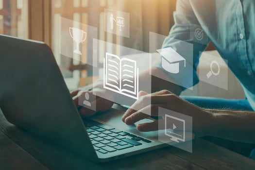A person on a computer with icons of a trophy, graduation cap, magnifying glass, video, book, target, and graph.