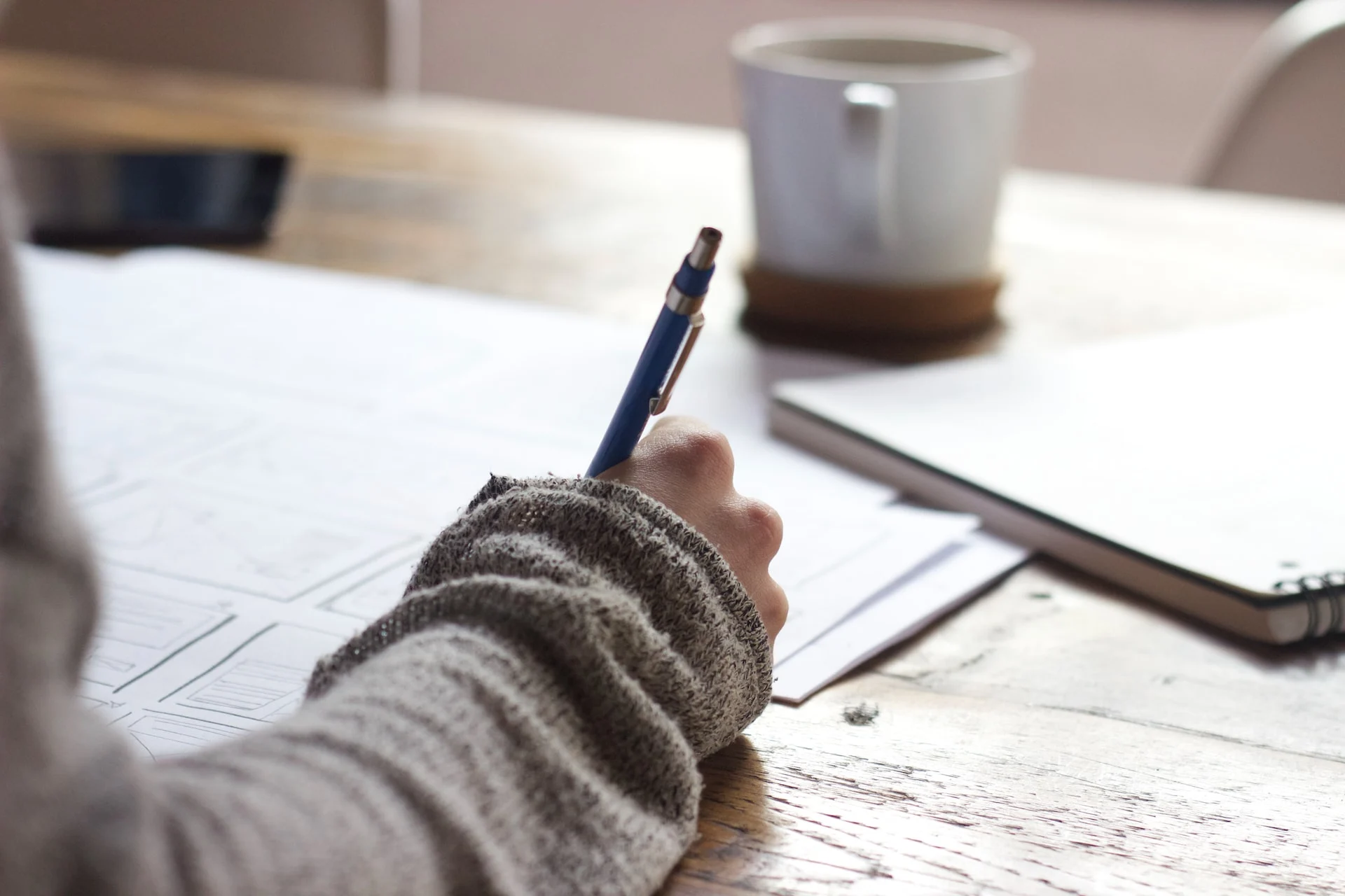 A person jotting notes on a piece of paper. 