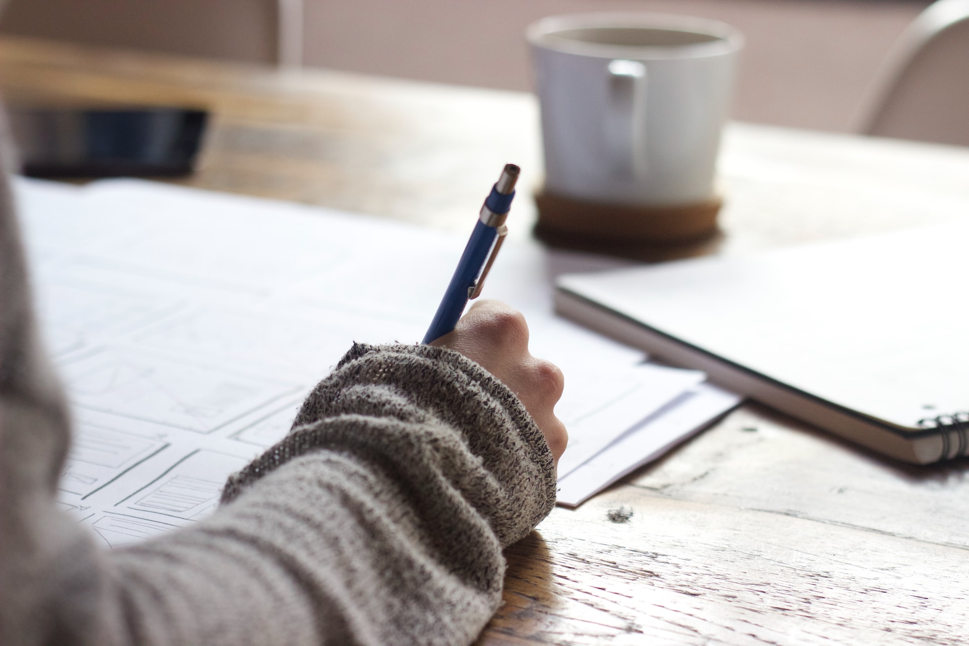 close up of hand writing on papers