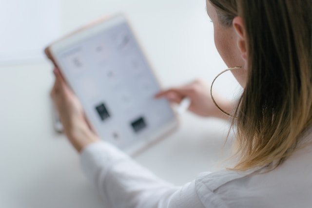 woman looking at tablet